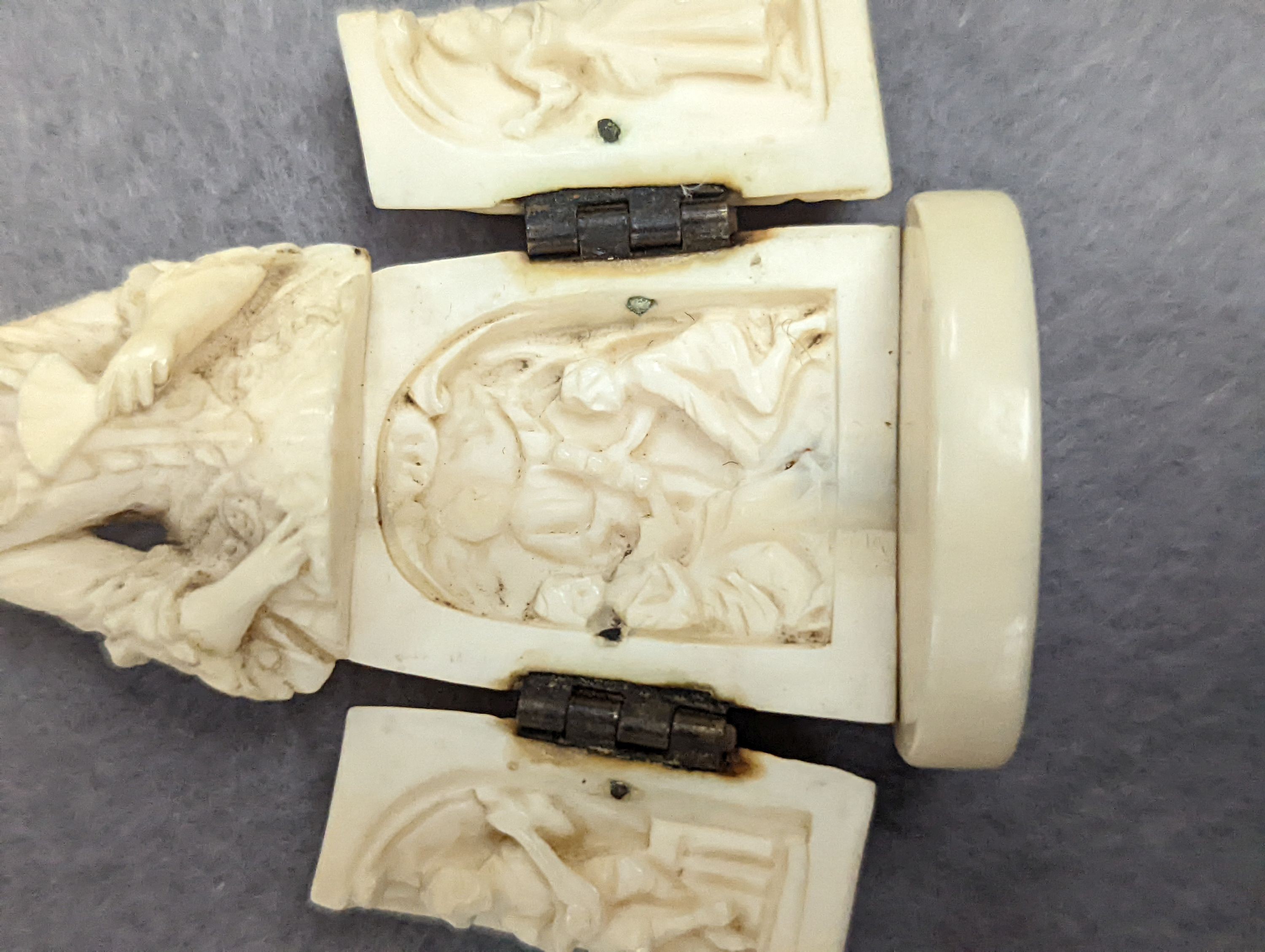 A pair of 19th century ivory balm pots, 3.75cm., a smallDieppe triptych figure, 6.5cm. a Meiji tiger brooch and a Dutch page marker.